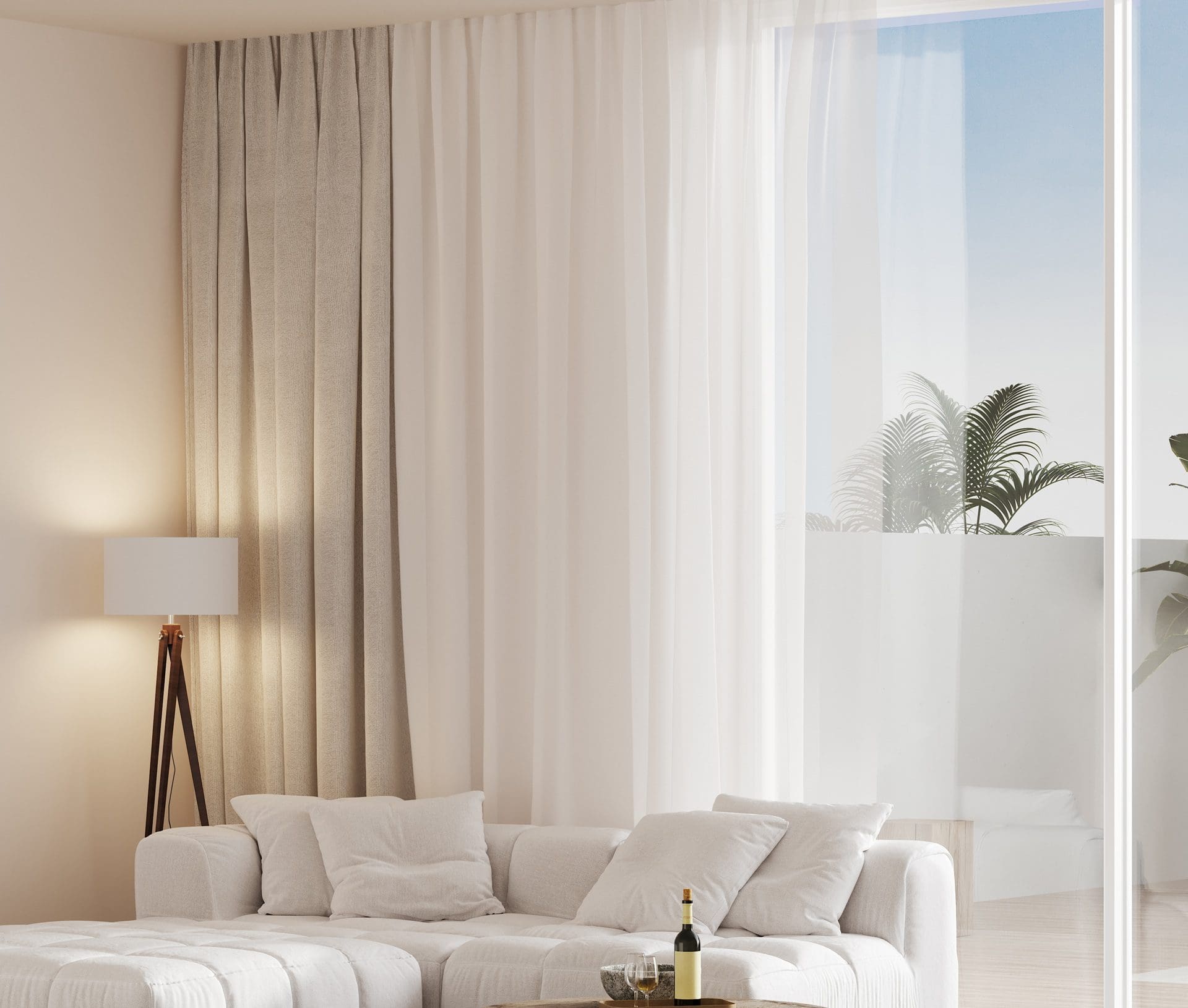 Minimalist living room with a white sofa, floor lamp, and curtains. A glass door opens to a balcony with plants and a clear sky view. Wine bottle on the table in front of the sofa.
